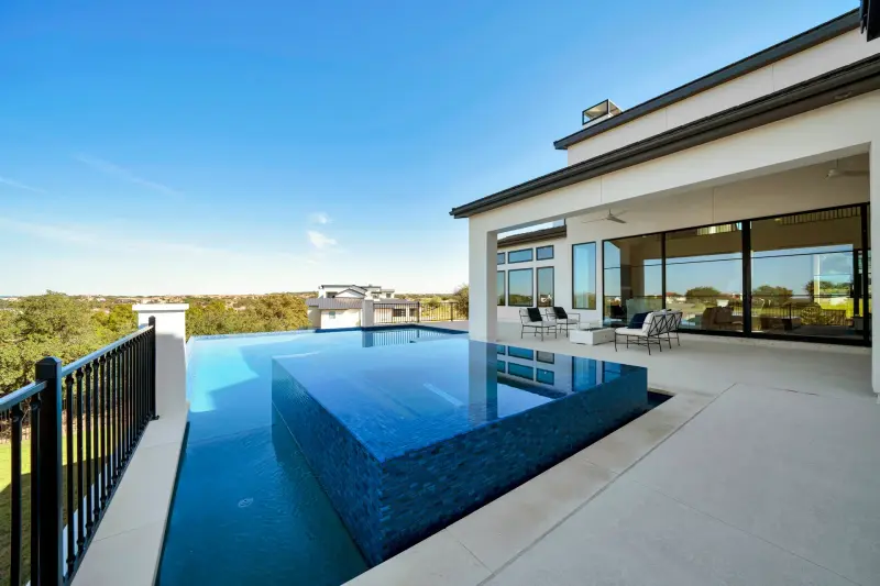 Infinity pool and covered patio overlooking Lake Travis — Austin real estate photography