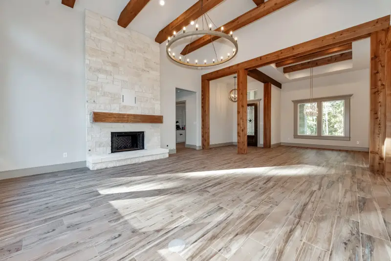 Strong hero, large room, fireplace focal point, beams, excellent light — Houston real estate photography