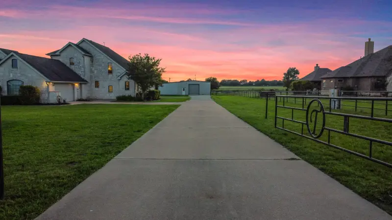 Home exterior at twilight under a colorful dusk sky — Houston real estate photography