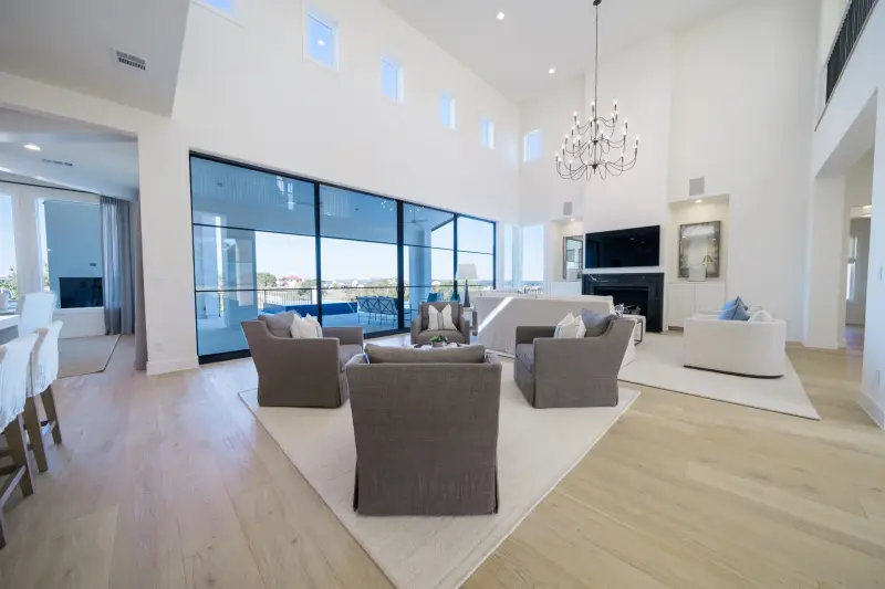 Walls-of-glass great room opening to a Lake Travis view — Austin real estate photography