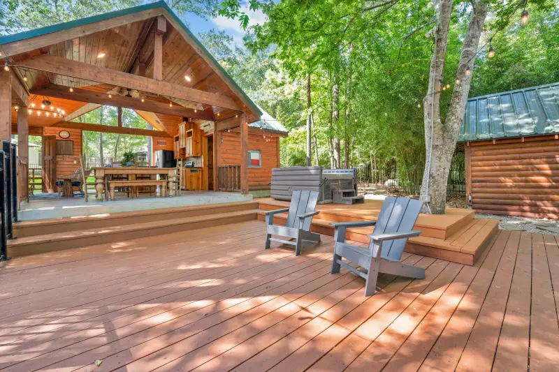 Log-framed covered patio with outdoor seating. — Houston real estate photography