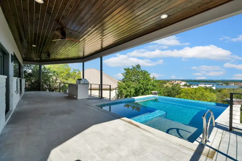Covered patio and infinity pool over Lake LBJ — Austin real estate photography